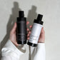 Meera Capsule Shampoo + Conditioner Bundle close-up — amber glass bottles with minimalist labels on neutral background