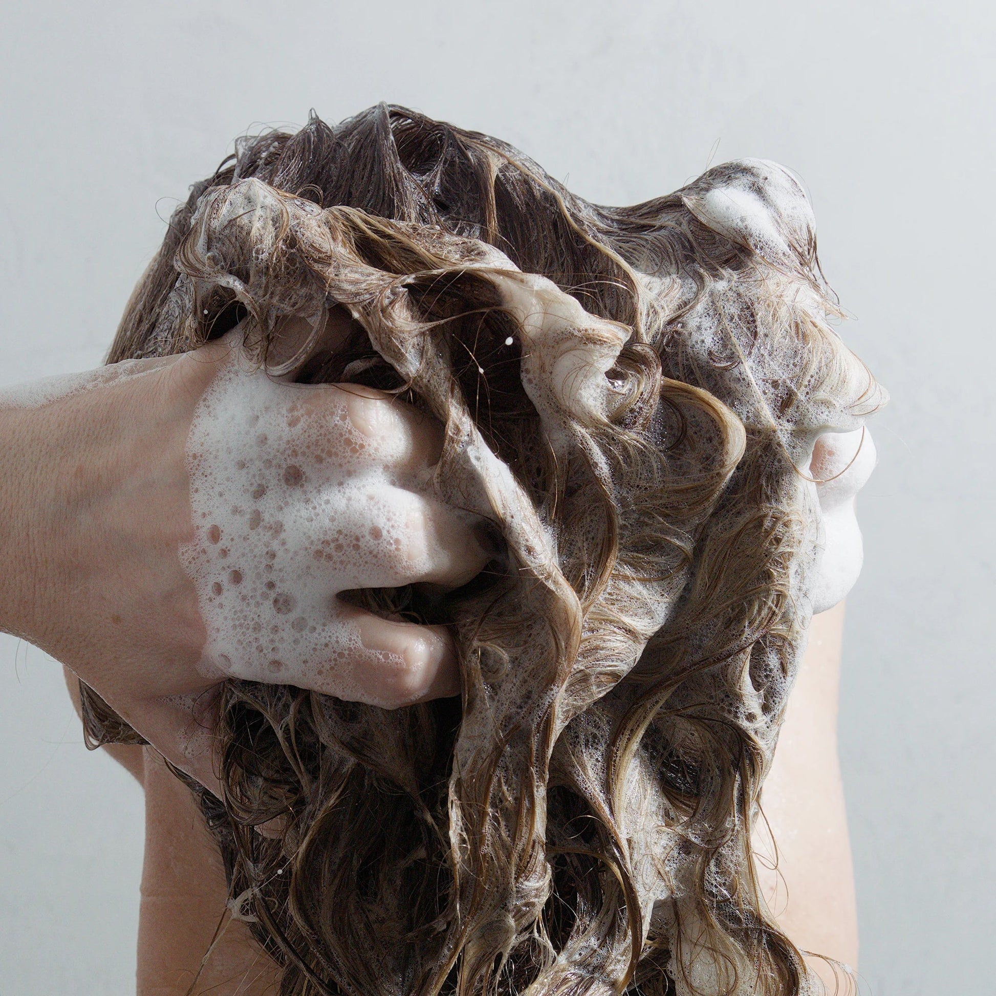 Rebalancing Shampoo lifestyle shot — pH-optimized deep follicle purification