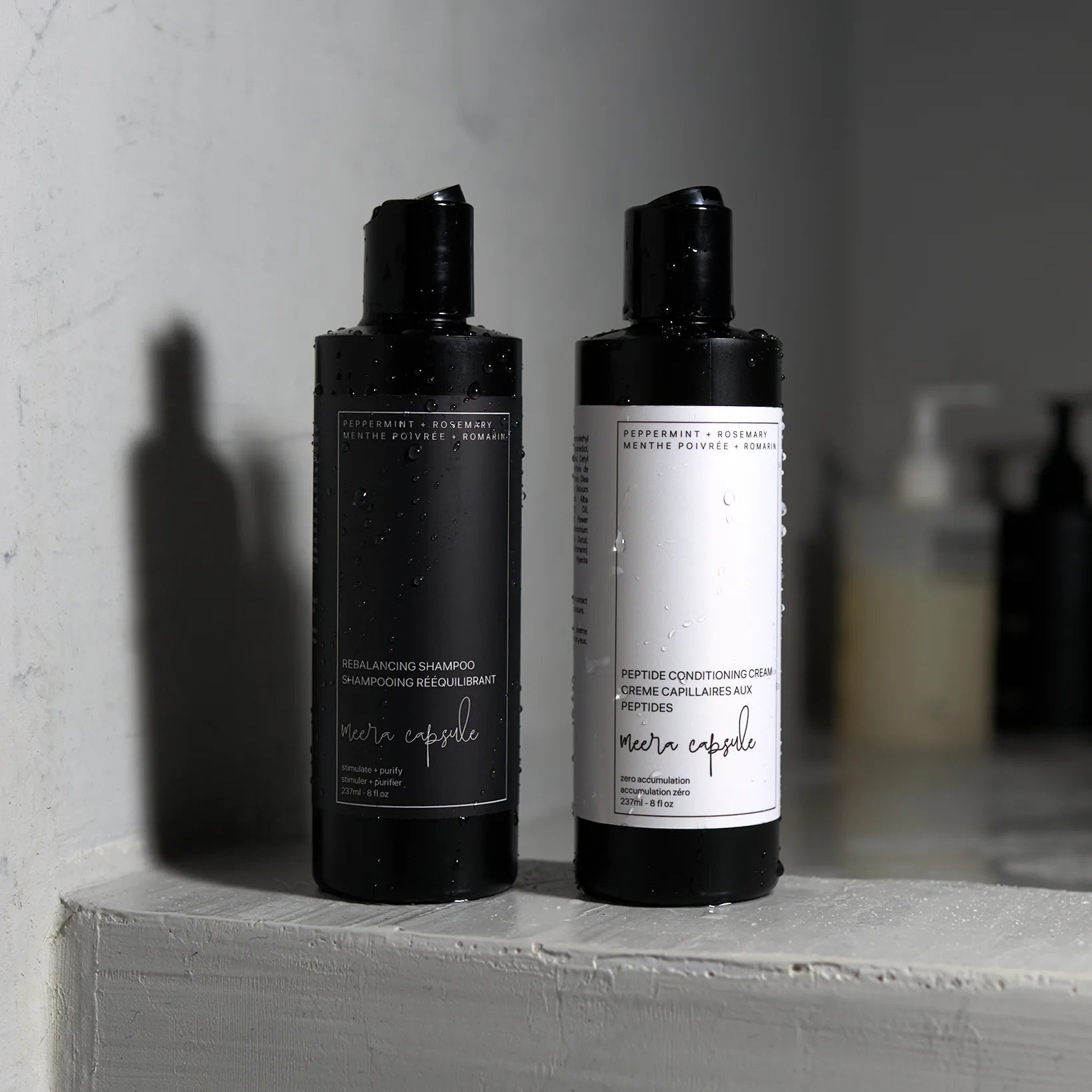 Meera Capsule Rebalancing Shampoo and Peptide Conditioning Cream — styled product shot of the duo bundle